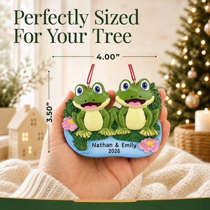 Size guide: the personalized frog pond couple christmas ornament is 4.00 in wide by 3.50 in tall, shown in hand