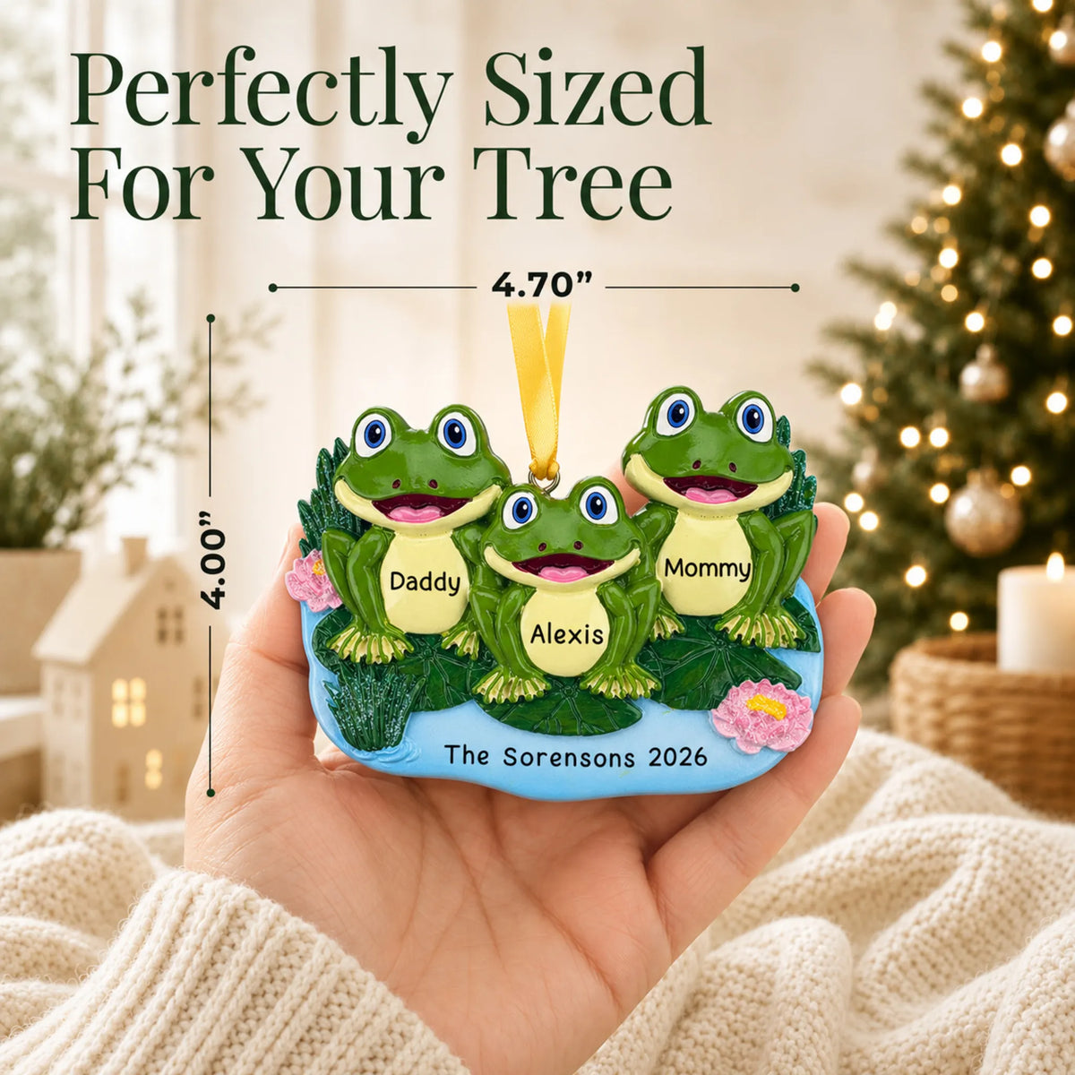 Size guide: the personalized frog family of 3 christmas ornament is 4.70 in wide by 4.00 in tall, shown in hand