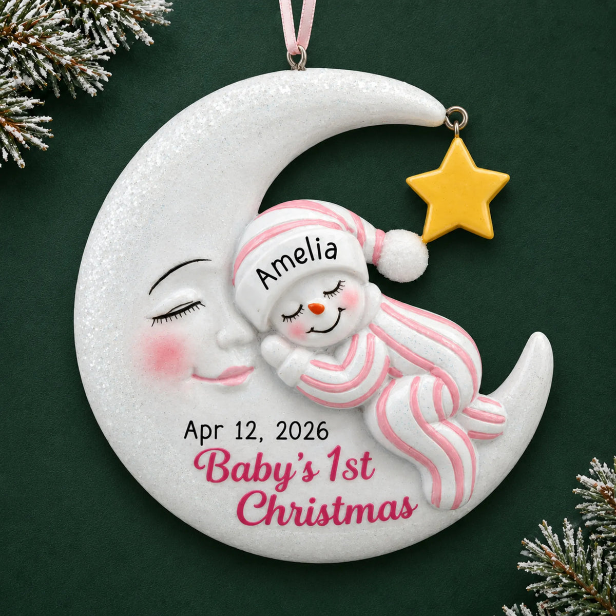 Personalized pink snowman baby's 1st christmas ornament on a dark green pine background
