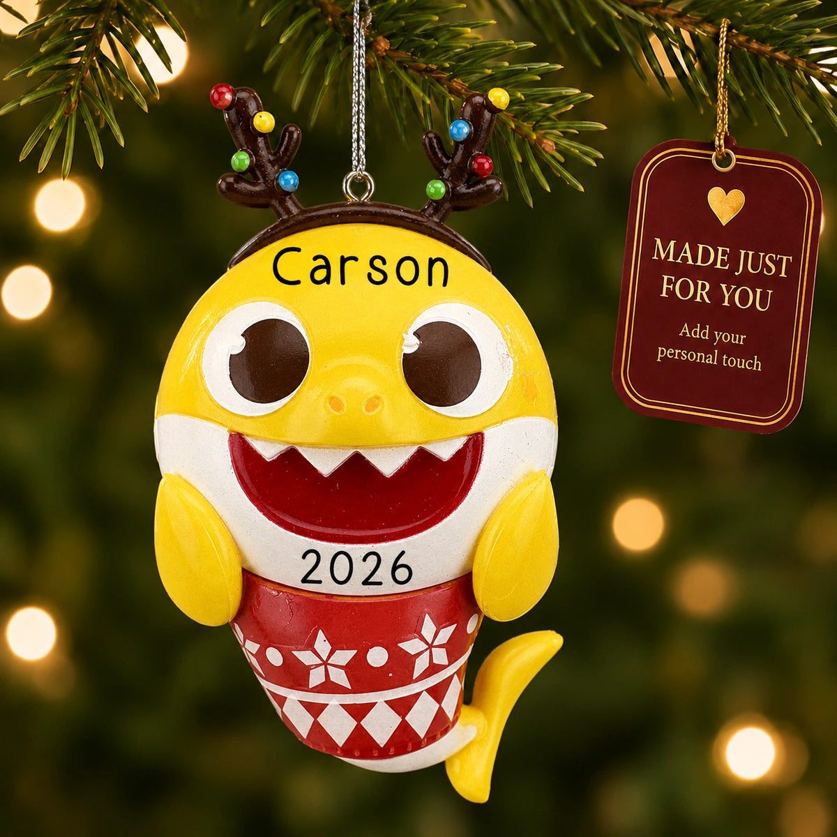 Personalized Baby Shark Christmas ornament hanging on a lit Christmas tree beside a Made Just For You gift tag