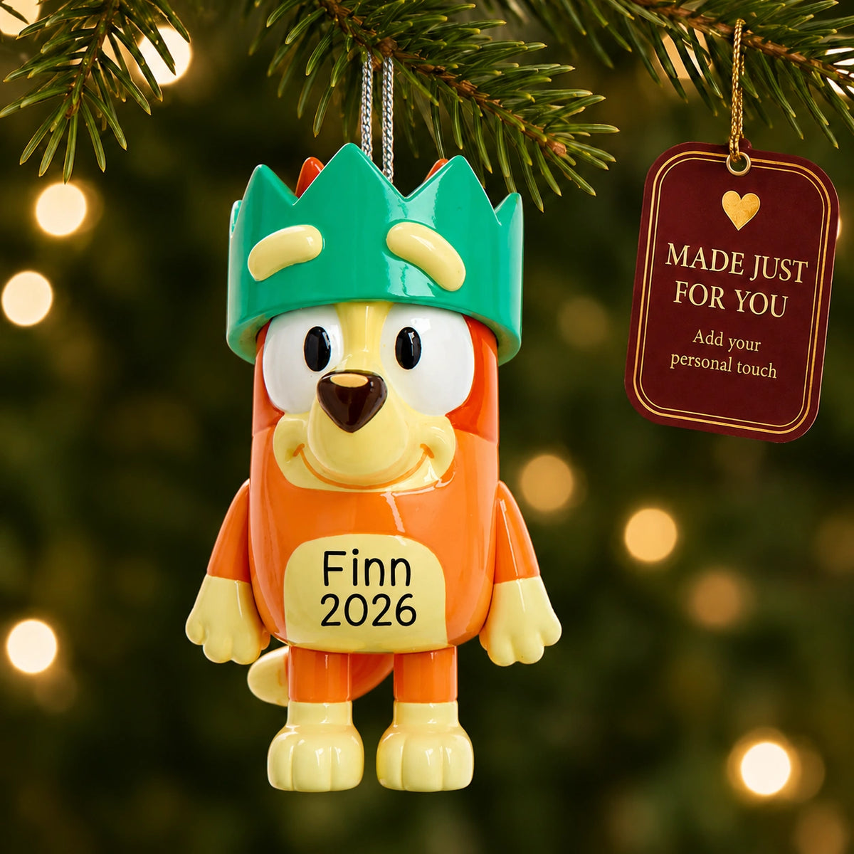 Personalized Bingo with crown Christmas ornament hanging on a lit Christmas tree beside a Made Just For You gift tag