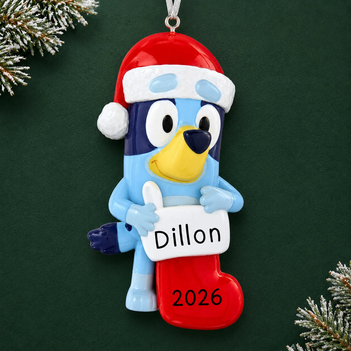Personalized Bluey Stocking christmas ornament on a dark green pine background
