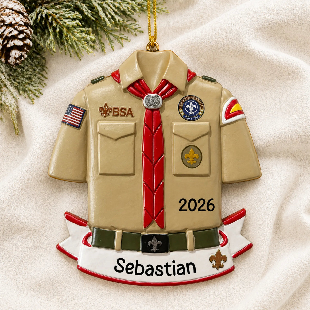 Personalized Boy Scouts banner christmas ornament laid on a soft white knit blanket