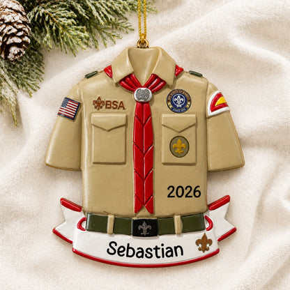 Personalized Boy Scouts banner christmas ornament laid on a soft white knit blanket