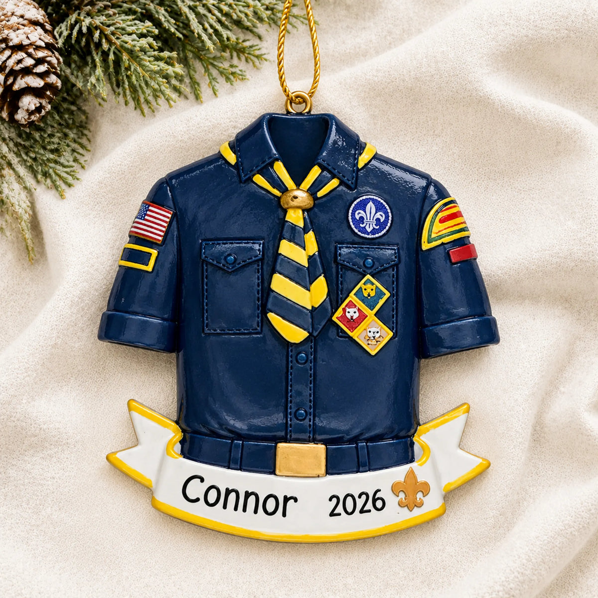 Personalized Cub Scout Boy Scouts christmas ornament laid on a soft white knit blanket
