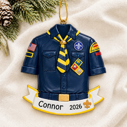 Personalized Cub Scout Boy Scouts christmas ornament laid on a soft white knit blanket