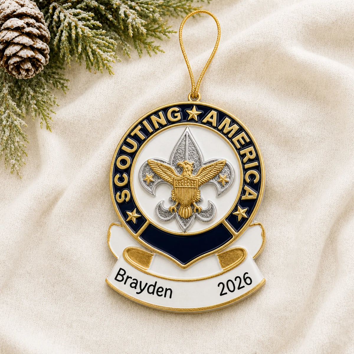 Personalized Scouting America christmas ornament laid on a soft white knit blanket