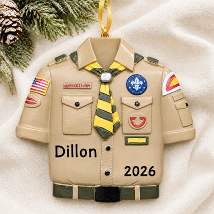 Personalized Boy Scouts uniform christmas ornament laid on a soft white knit blanket