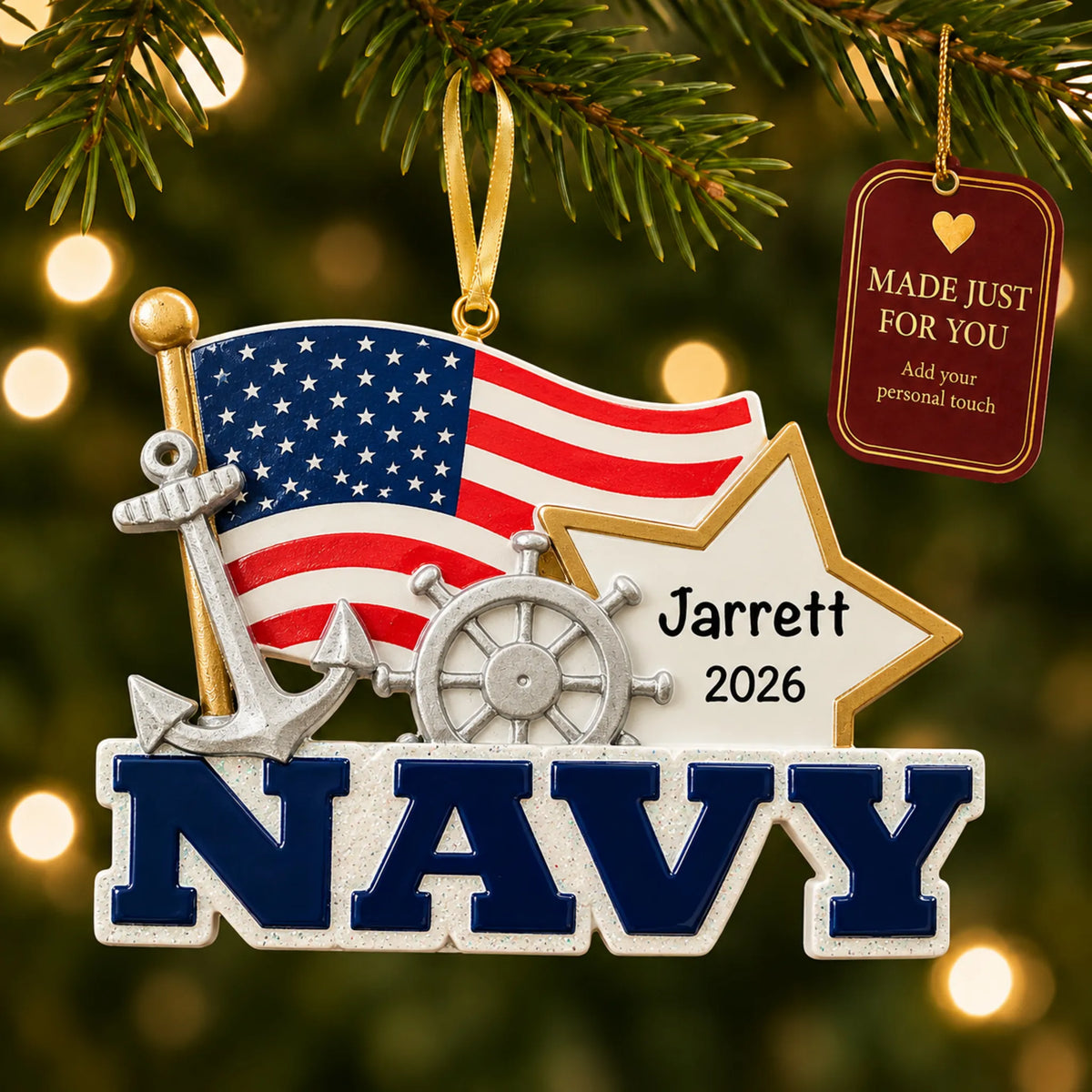 Personalized U.S. Navy flag and star Christmas ornament hanging among tree lights with a Made Just For You tag