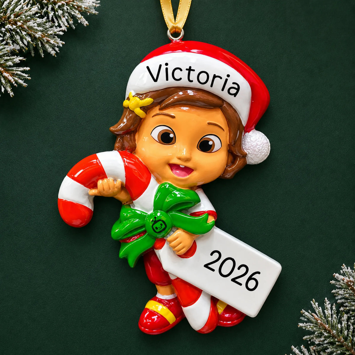 Personalized CoComelon Nina christmas ornament on a dark green pine background
