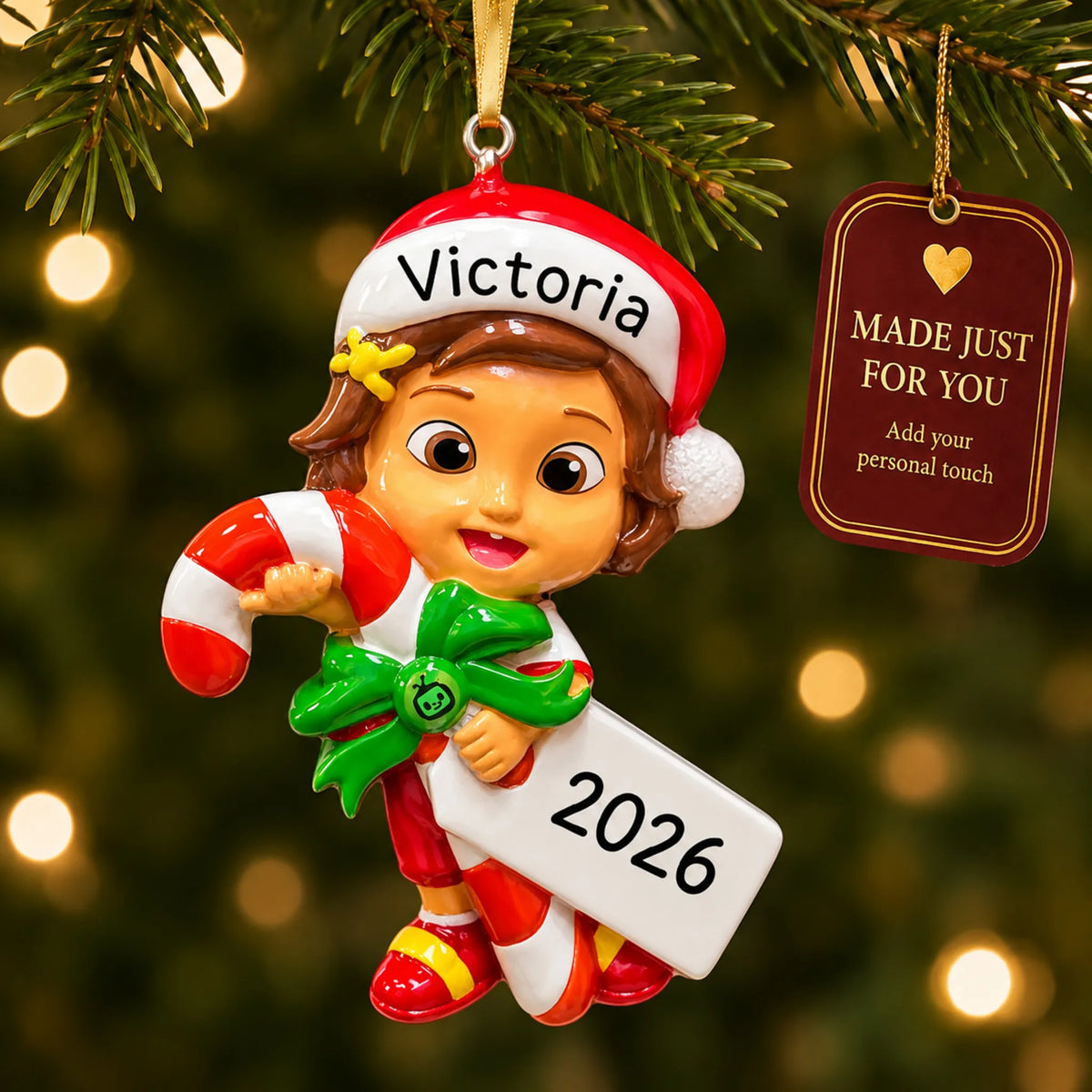 CoComelon Nina christmas ornament hanging on a lit Christmas tree with a Made Just For You gift tag