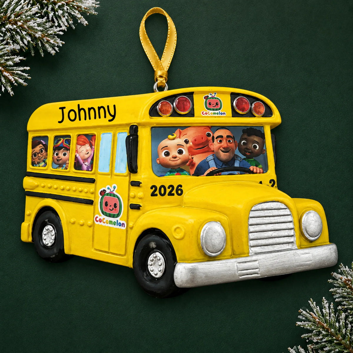 Personalized CoComelon School Bus christmas ornament on a dark green pine background