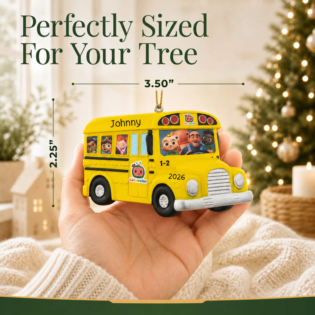 Size guide: the personalized CoComelon School Bus christmas ornament is 3.50 in wide by 2.25 in tall, shown in hand