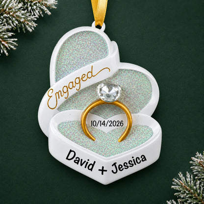Personalized engagement ring box Christmas ornament with a gold ring in a glitter heart box with names and date