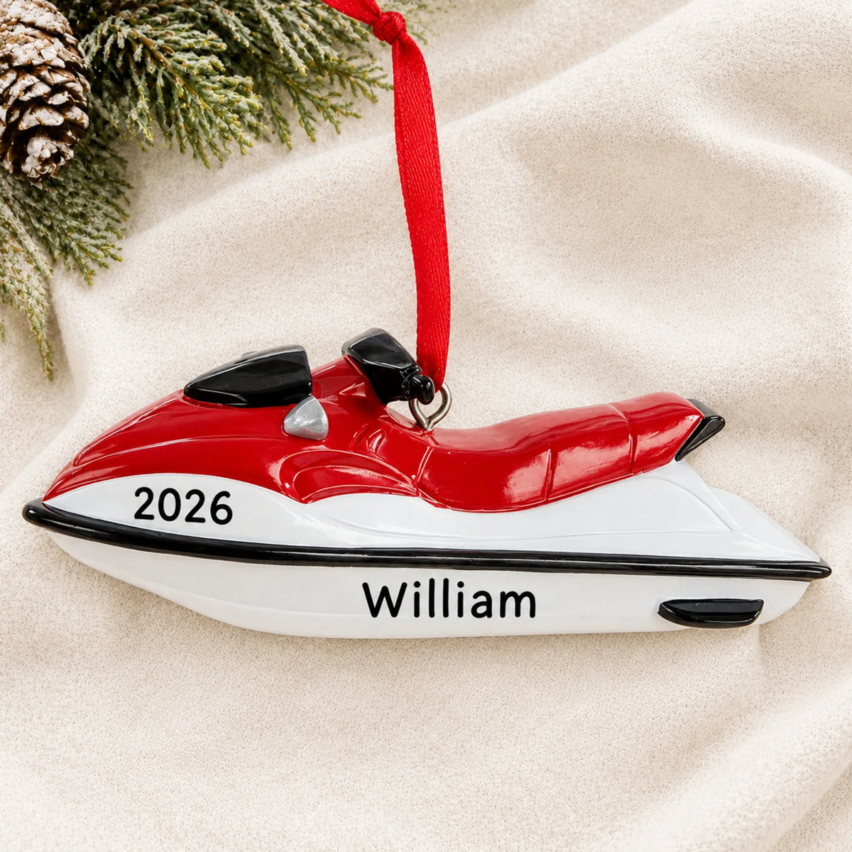 Personalized 3D jet ski christmas ornament laid on a soft white knit blanket