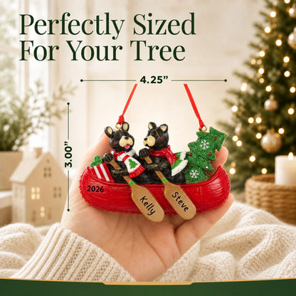 Size guide: the personalized bear canoe couple christmas ornament is 4.25 in wide by 3.00 in tall, shown in hand