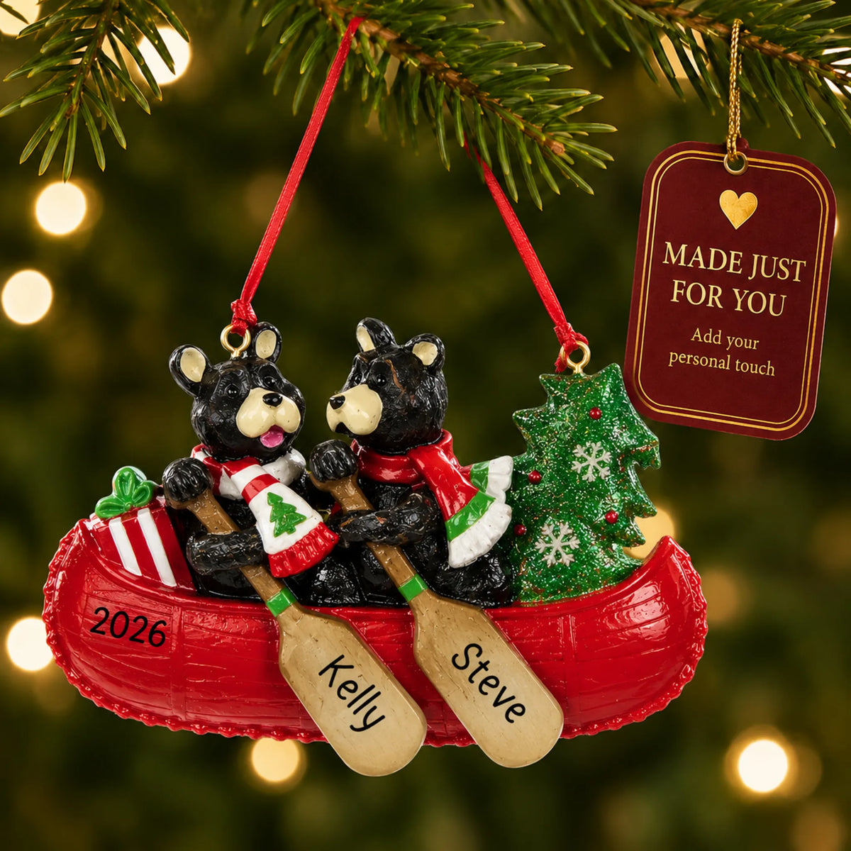 Bear canoe couple christmas ornament hanging on a lit Christmas tree with a Made Just For You gift tag