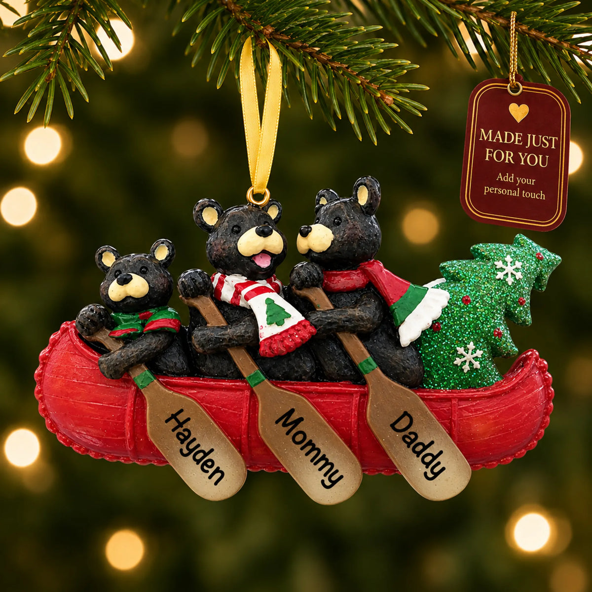Bear canoe family of 3 christmas ornament hanging on a lit Christmas tree with a Made Just For You gift tag