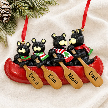 Personalized bear canoe family of 4 christmas ornament laid on a soft white knit blanket