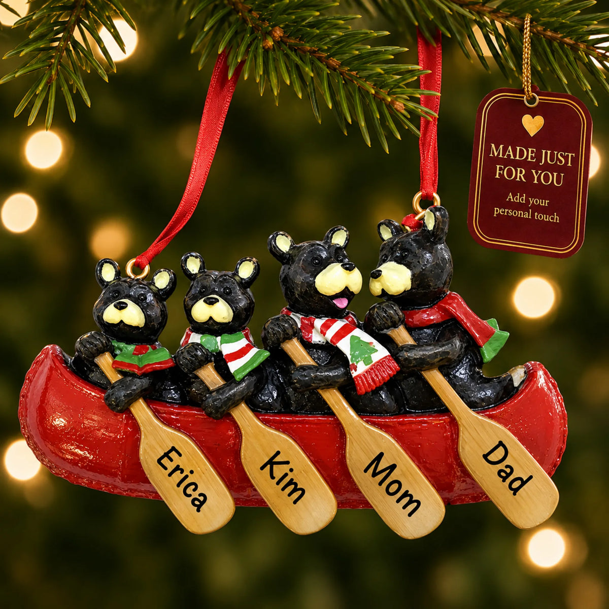 Bear canoe family of 4 christmas ornament hanging on a lit Christmas tree with a Made Just For You gift tag