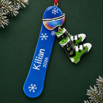 Personalized snowboard with boots christmas ornament on a dark green pine background