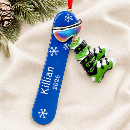 Personalized snowboard with boots christmas ornament laid on a soft white knit blanket