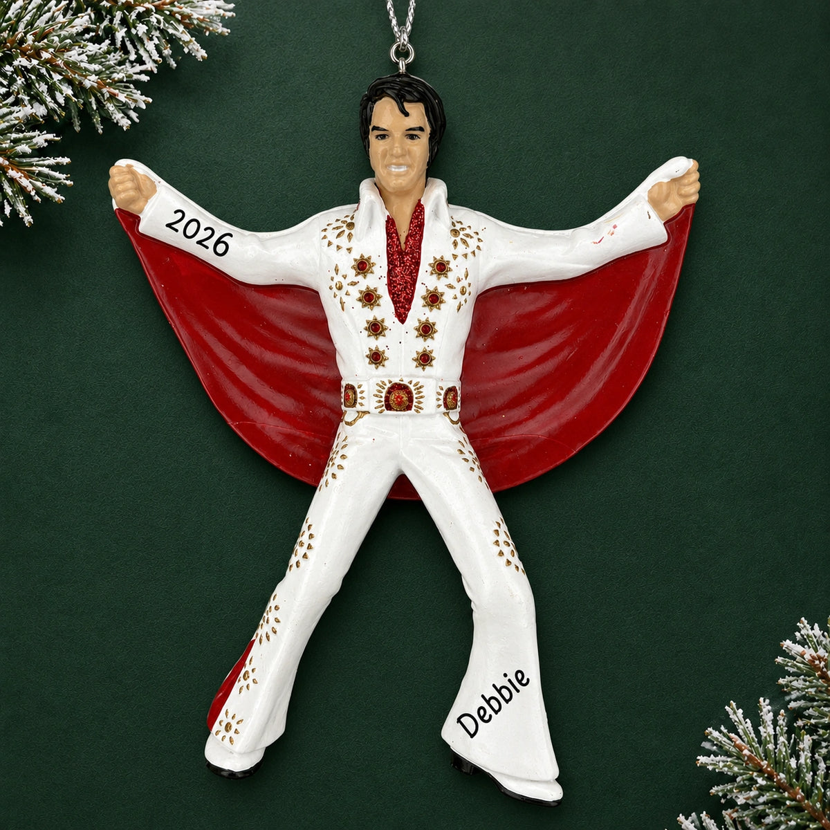 Personalized Elvis Presley Christmas ornament reading Debbie and 2026, shown on a dark green background with pine