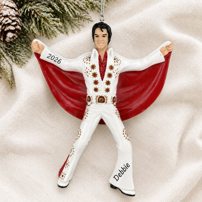 Personalized Elvis Presley Christmas ornament reading Debbie and 2026 on a white knit blanket with pine