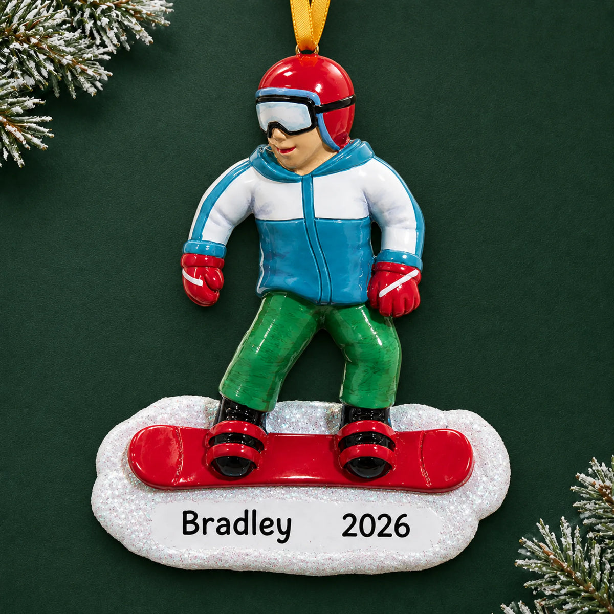 Personalized snowboarding guy christmas ornament on a dark green pine background