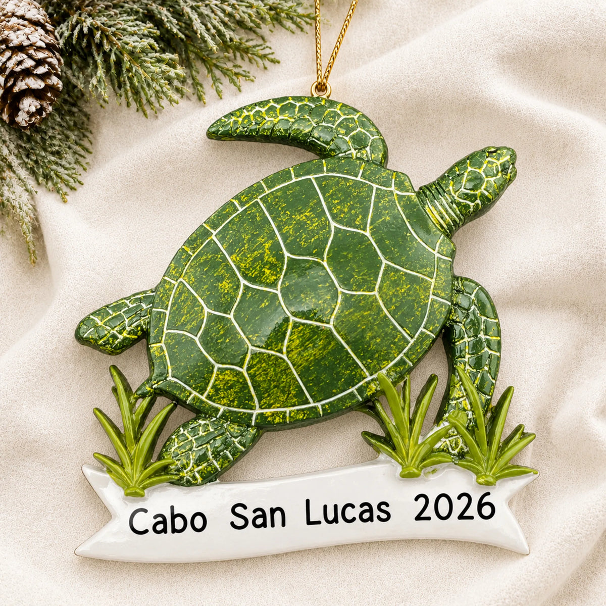 Personalized sea turtle christmas ornament laid on a soft white knit blanket