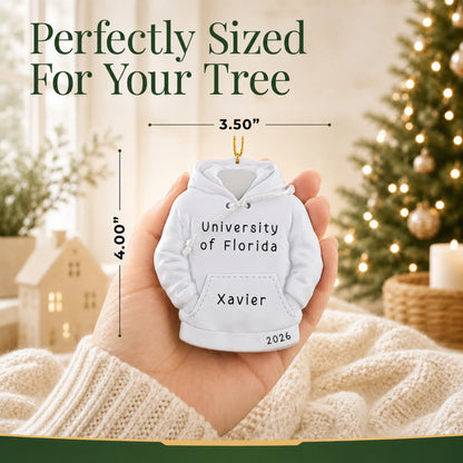 Personalized college hoodie Christmas ornament held in hand to show its size on the tree