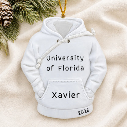 Personalized college hoodie Christmas ornament shown on a soft white blanket