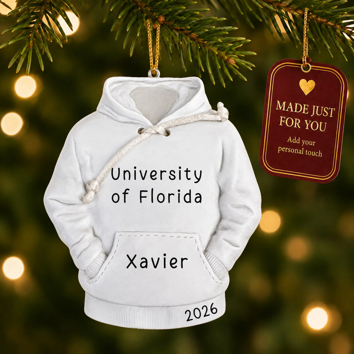 Personalized college hoodie Christmas ornament hanging among tree lights with a Made Just For You tag