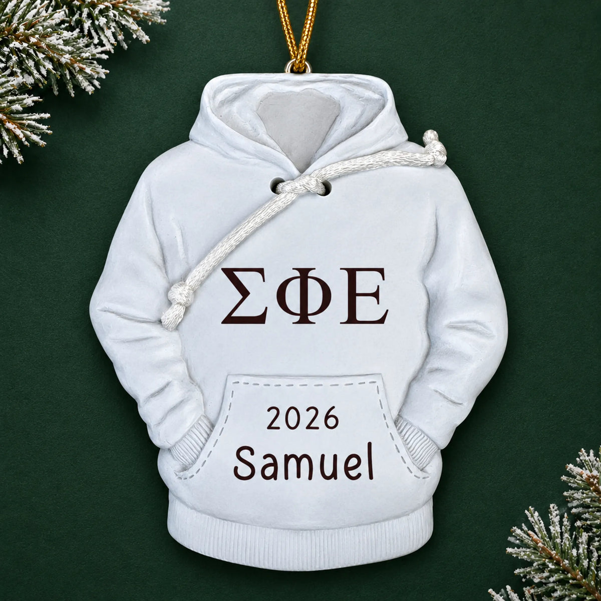 Personalized fraternity hoodie Christmas ornament with name and year, shown on a green holiday background
