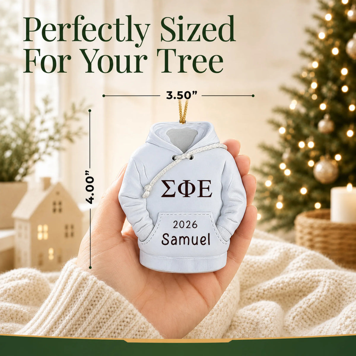 Personalized fraternity hoodie Christmas ornament held in hand to show its size on the tree