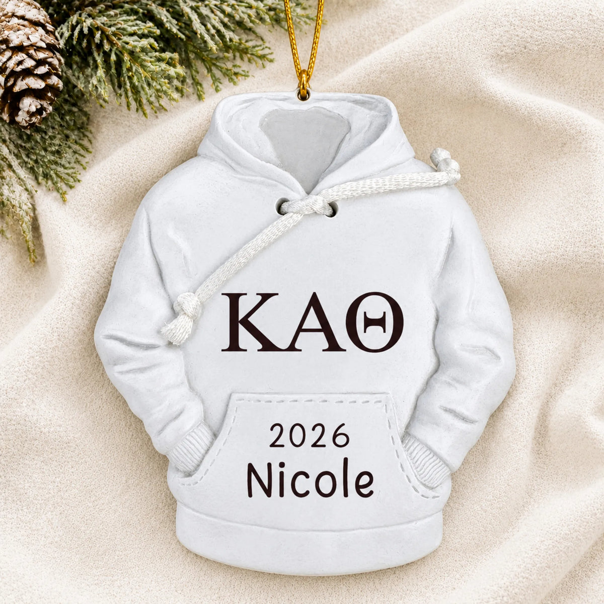 Personalized sorority hoodie Christmas ornament shown on a soft white blanket