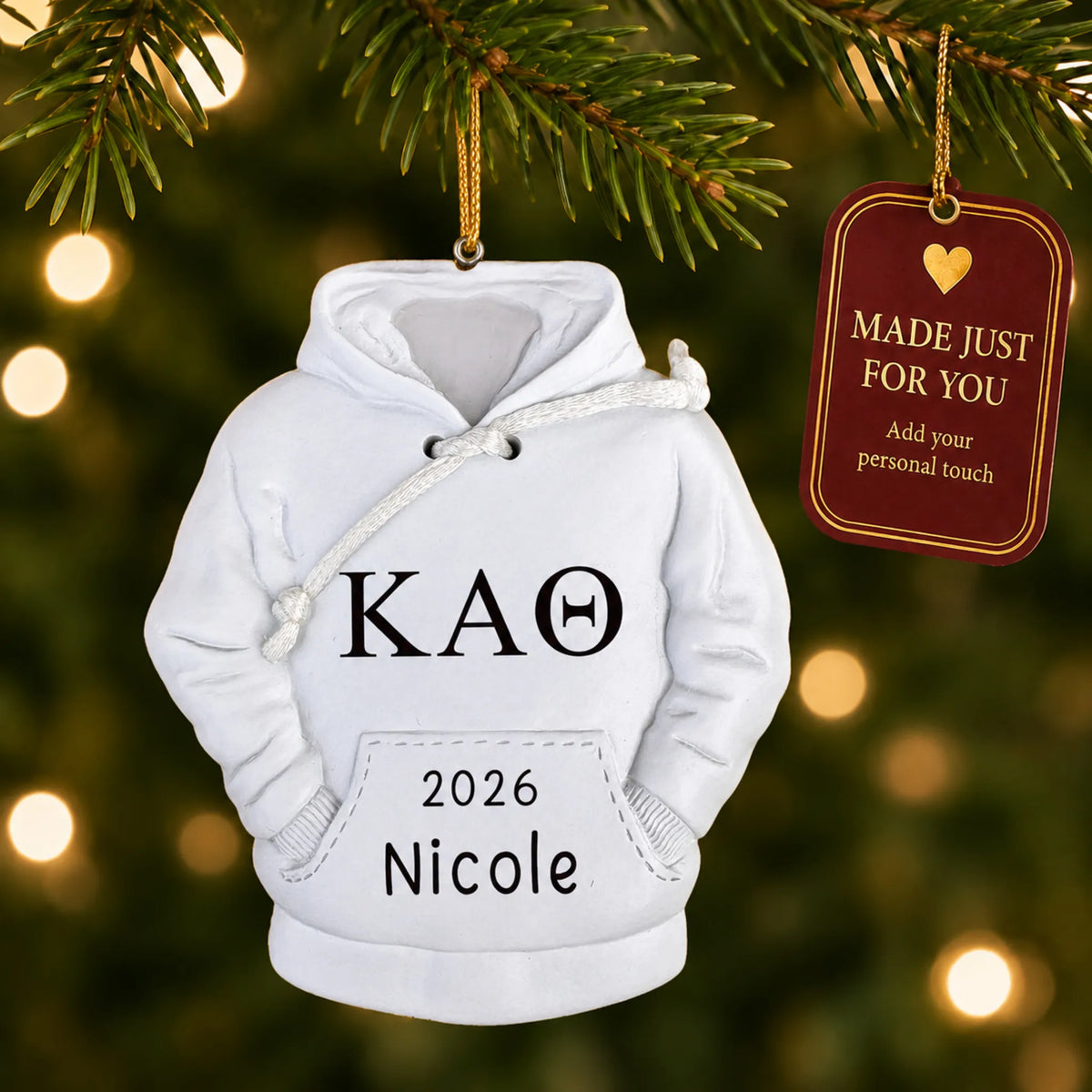 Personalized sorority hoodie Christmas ornament hanging among tree lights with a Made Just For You tag