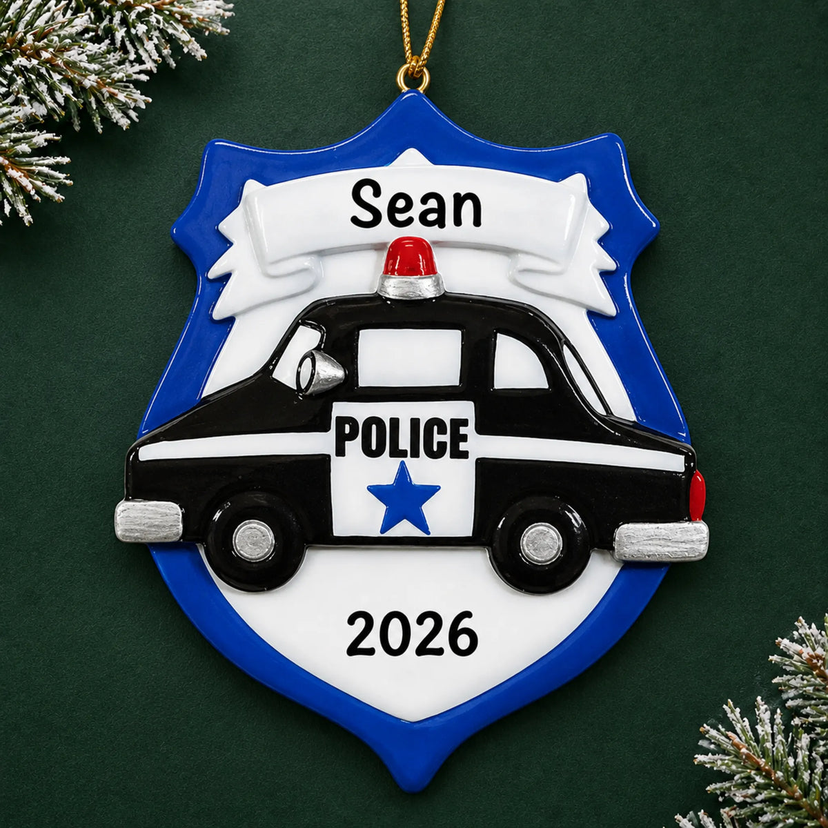 Personalized police badge emblem christmas ornament on a dark green pine background