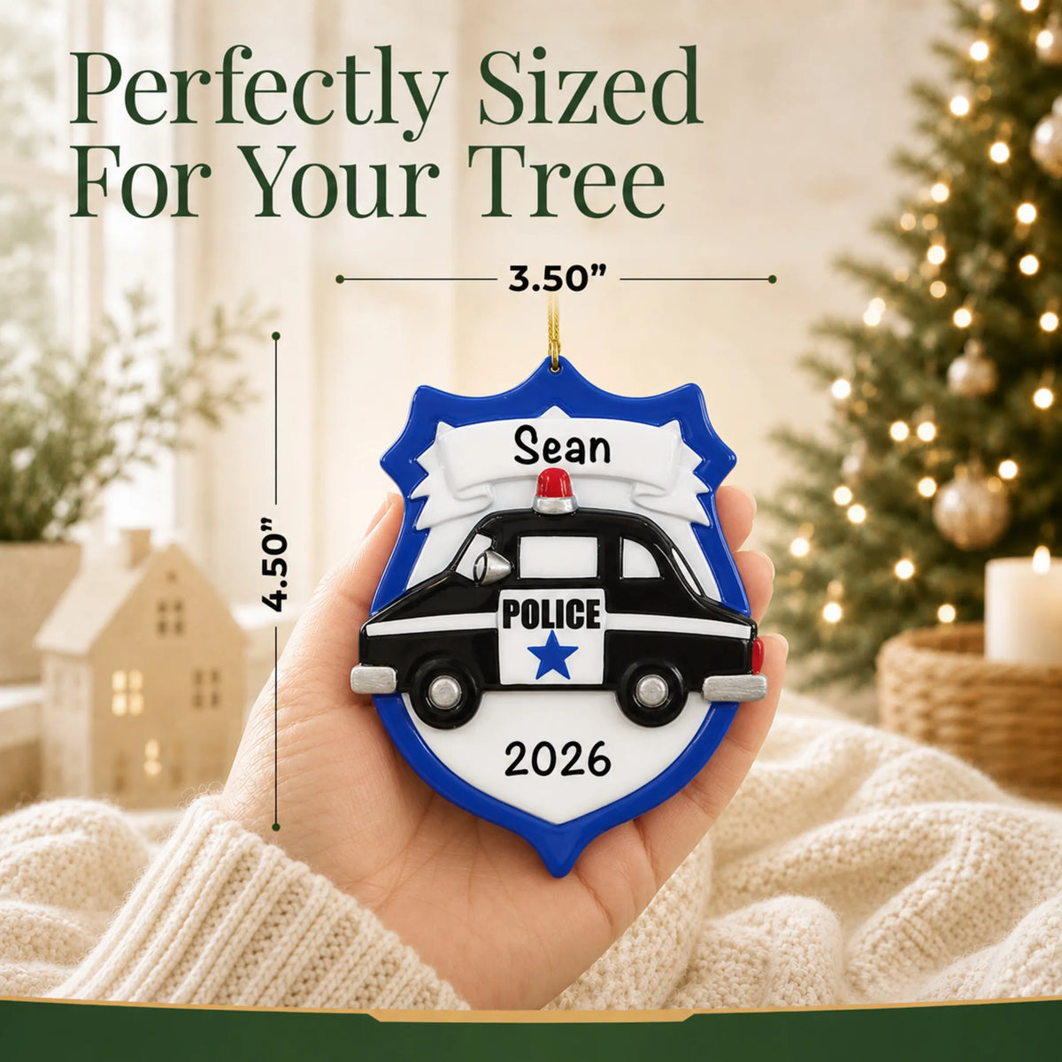 Size guide: the personalized police badge emblem christmas ornament is 3.50 in wide by 4.50 in tall, shown in hand
