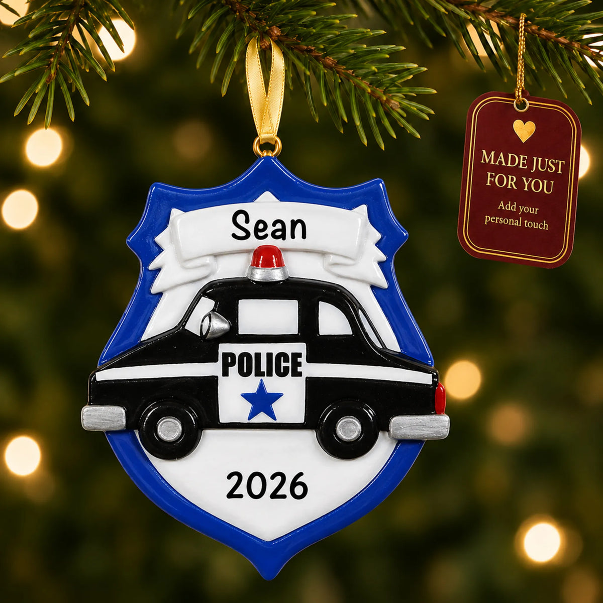 Police badge emblem christmas ornament hanging on a lit Christmas tree with a Made Just For You gift tag
