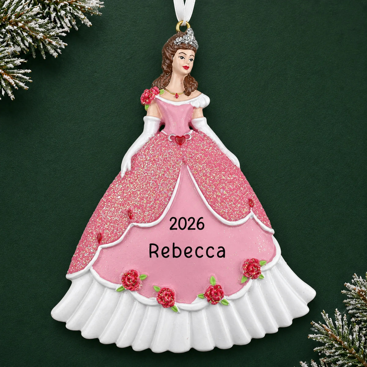 Personalized princess pink dress christmas ornament on a dark green pine background