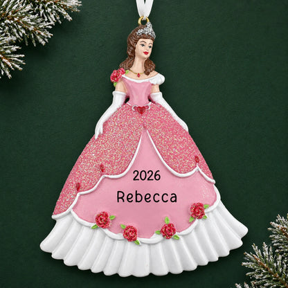Personalized princess pink dress christmas ornament on a dark green pine background