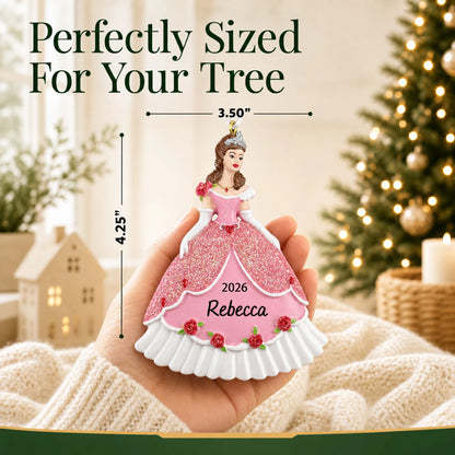 Size guide: the personalized princess pink dress christmas ornament shown in hand next to a Christmas tree