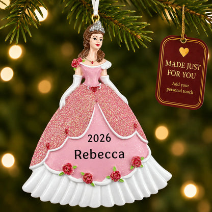 Princess pink dress christmas ornament hanging on a lit Christmas tree with a Made Just For You gift tag