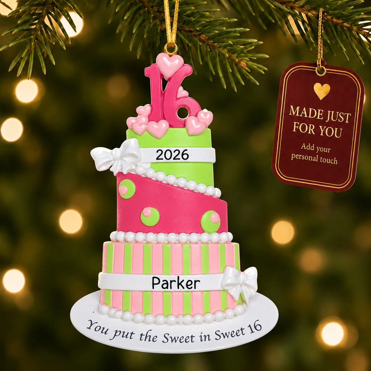 Sweet 16 birthday cake christmas ornament hanging on a lit Christmas tree with a Made Just For You gift tag
