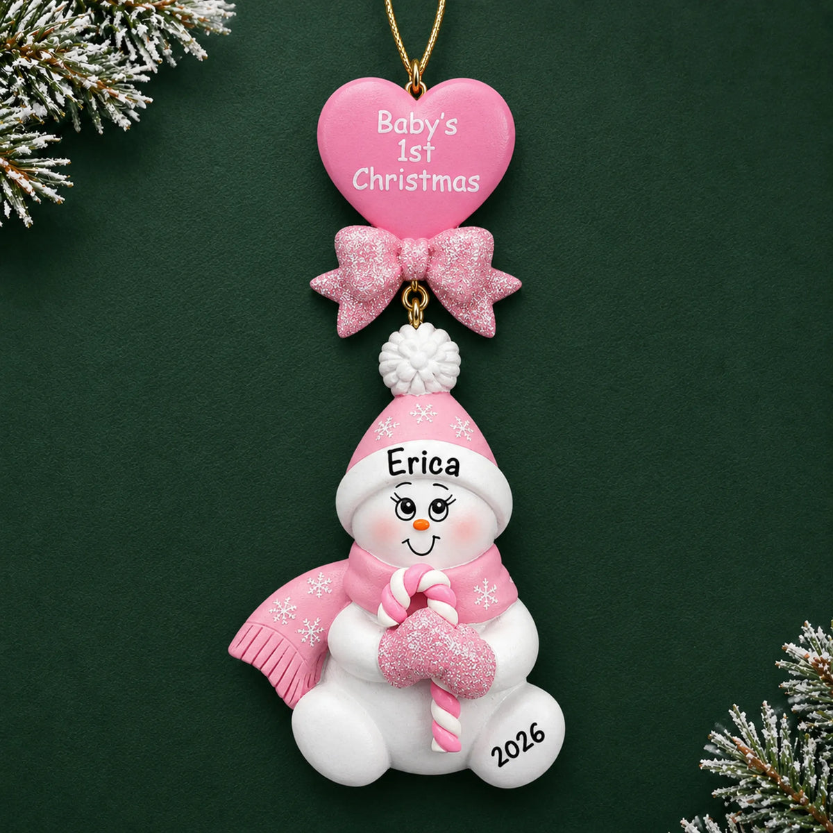 Personalized pink baby's 1st christmas candy cane snowbaby ornament on a dark green pine background
