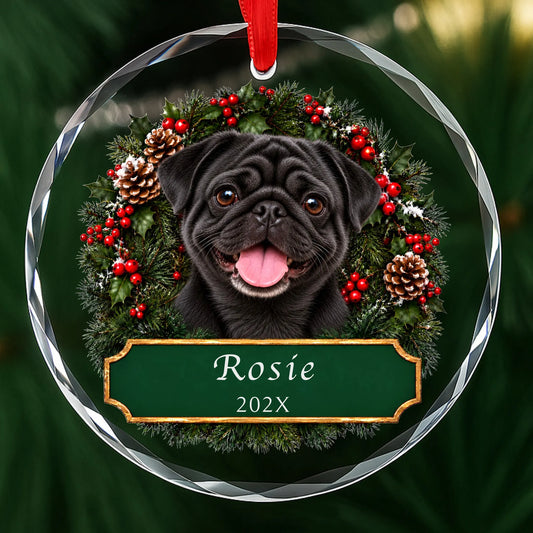 Personalized black Pug Christmas ornament in round glass with a holly wreath and a green plaque engraved with a name and year