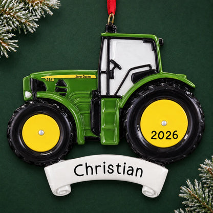 Personalized green farm tractor christmas ornament on a dark green pine background