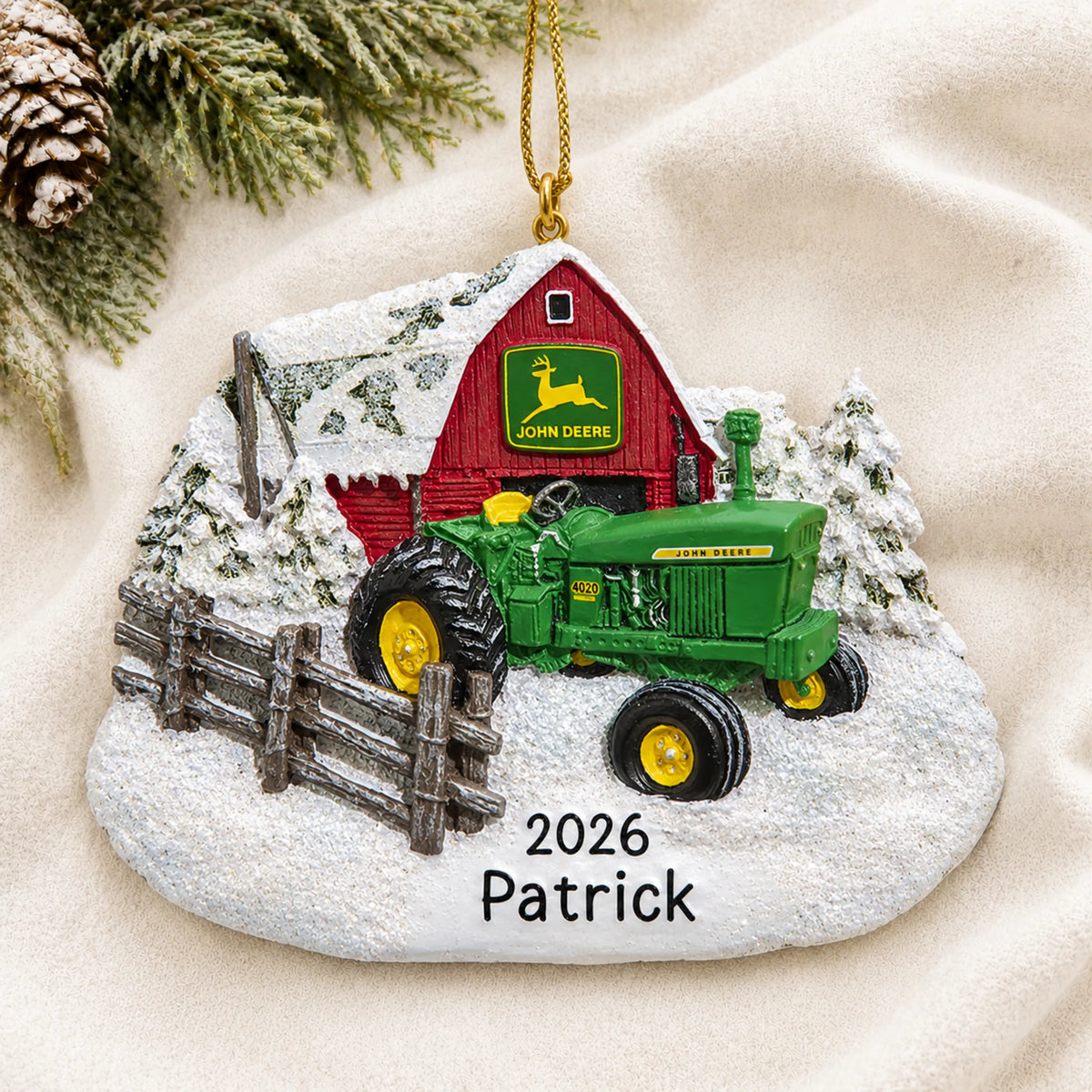 Personalized green farm tractor christmas ornament laid on a soft white knit blanket