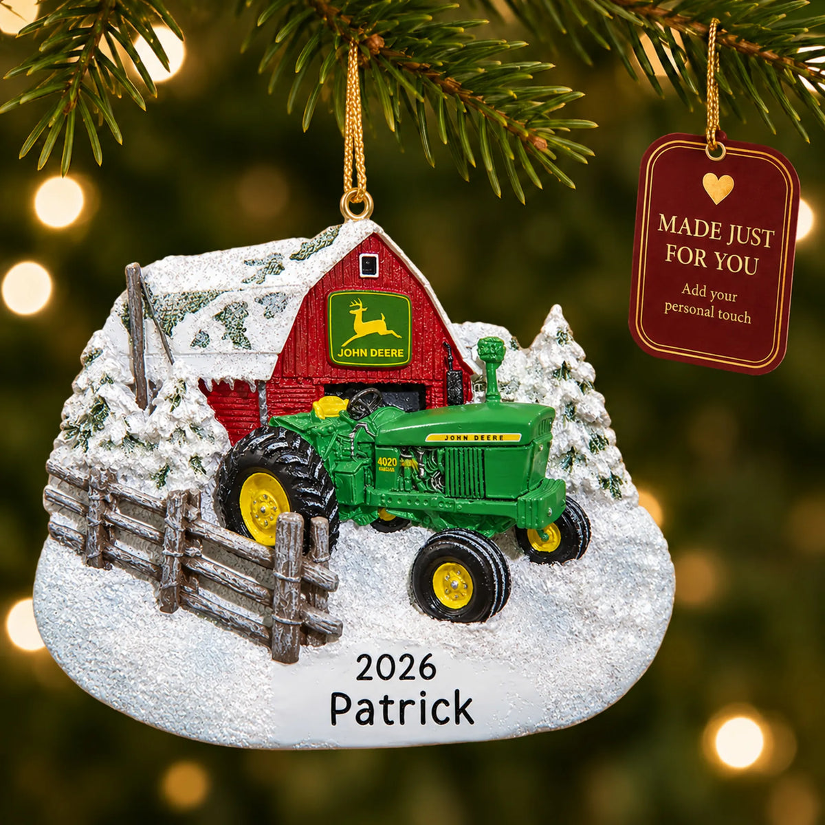 Green farm tractor christmas ornament hanging on a lit Christmas tree with a Made Just For You gift tag